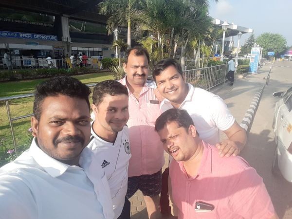Group of travellers with South Moon driver at the airport – Best Tour Travel Agency in Madurai